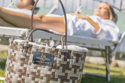 a woman laying in a hospital bed with a basket at Miraval Hotel in Coredo