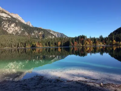 a reflection of a mountain in a lake at Miraval Hotel in Coredo
