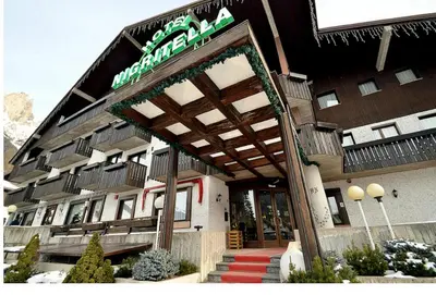 a hotel with a sign on the front of it at Hotel Nigritella in Selva di Cadore
