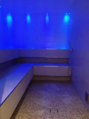 a blue room with a bench with blue lights at Relais San Giusto in Campitello di Fassa