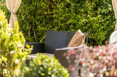 a table and chairs with a paper bag on it at Mounthotel Niggl in Nova Levante
