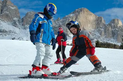 a group of people on skis in the snow at Mounthotel Niggl in Nova Levante