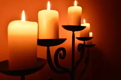 a group of lit candles in front of a wall at Hotel Garnì Carpe Diem in Vigo di Fassa