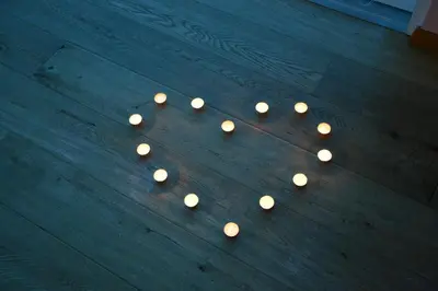 a group of lit candles on a wooden floor at Hotel Garnì Carpe Diem in Vigo di Fassa