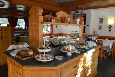a kitchen with a buffet of food on a counter at Hotel Garnì Carpe Diem in Vigo di Fassa