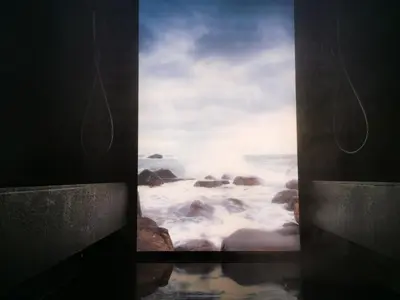 a window with a view of the ocean and rocks at Hotel Luna Mondschein in Ortisei