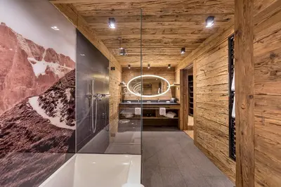 a bathroom with a tub and a glass shower at Hotel Cappella in Colfosco
