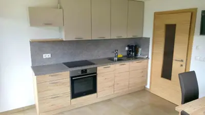 a kitchen with a sink and a stove top oven at Agriturismo Gfaderhof in Bressanone