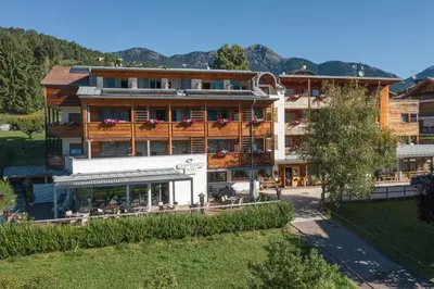 a building with snow in front of it at Olimpionico Hotel in Castello di Fiemme