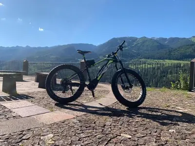 a bike is parked on a stone ground at Hotel Alla Rocca in Varena