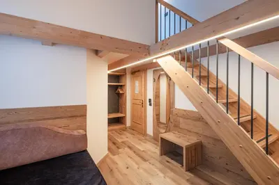 a staircase in a house with wooden flooring at Hotel Bellavista in Cavalese
