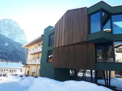 a building in the snow with snow around it at Parc Hotel Florian in Siusi