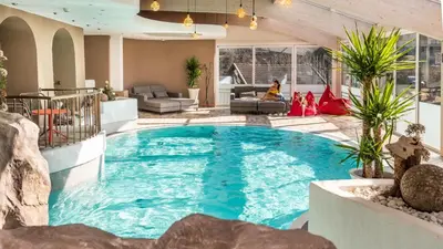 a large swimming pool in a house at Hotel Post - Olang in Valdaora
