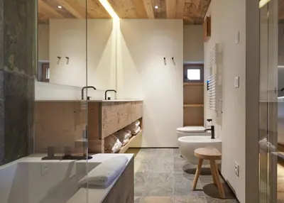 a bathroom with a tub and a toilet and a sink at HOTEL de LEN in Cortina dʼAmpezzo