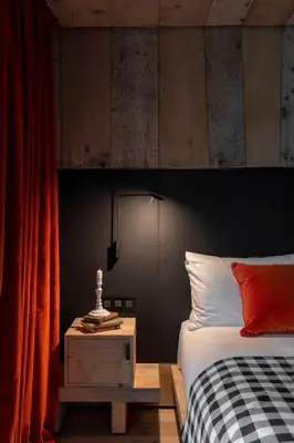 a bedroom with a bed with a black and red wall at HOTEL de LEN in Cortina dʼAmpezzo