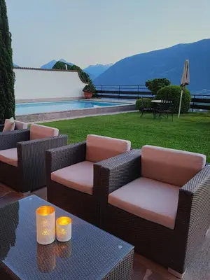 a patio with two chairs and a table at Hotel Walder in Schenna
