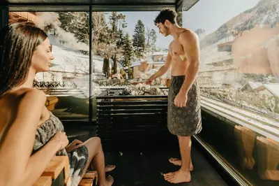 a man standing in a bar talking to a woman at Alpin Garden Luxury Maison & SPA - Adults Retreat in Ortisei