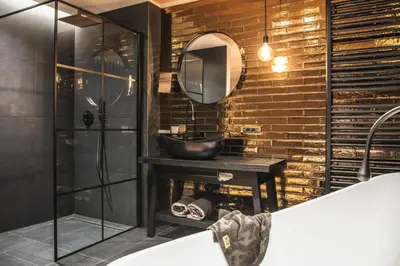 a bathroom with a sink and a mirror at Alpin Garden Luxury Maison & SPA - Adults Retreat in Ortisei