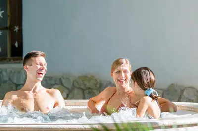 a group of people in a hot tub at Pineta Nature Resort - Wellness & SPA in Coredo