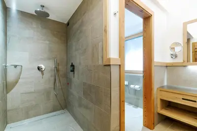 a bathroom with a shower and a sink at Pineta Nature Resort - Wellness & SPA in Coredo