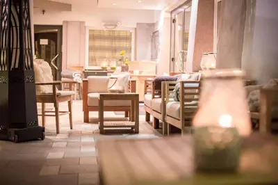 a living room with chairs and a table at Olympic SPA Hotel - Adults Only in Vigo di Fassa