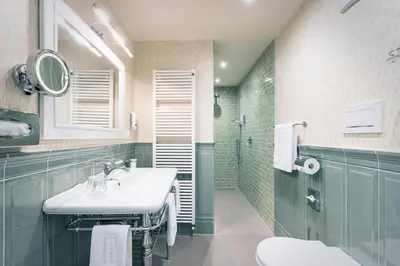 a bathroom with a sink and a shower at Parkhotel Holzner in Soprabolzano