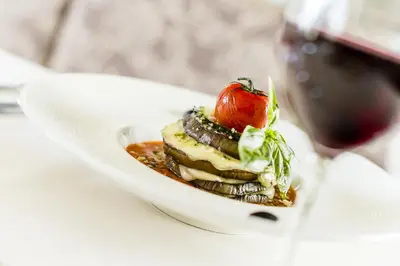 a dessert on a plate with a tomato on top at Astor Hotel in Schenna