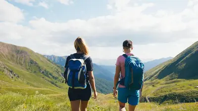 two people standing on a mountain looking at the valley at Moar's Hotel in Valdaora