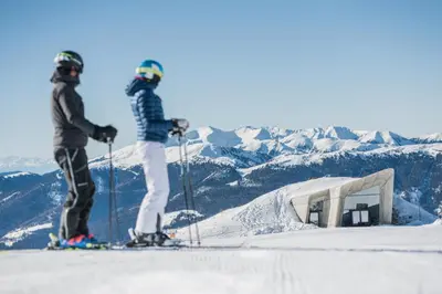 two people on skis on top of a snow covered mountain at Moar's Hotel in Valdaora