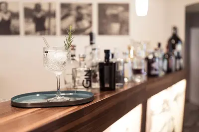 a bar with a wine glass sitting on a counter at Boutique Hotel Zum Rosenbaum in Nalles