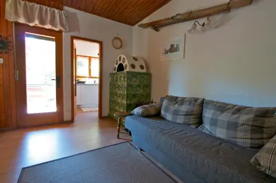 a living room with a couch and a table at Villa La Brisa in Predazzo