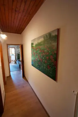 a painting of a field of flowers on a wall at Villa La Brisa in Predazzo
