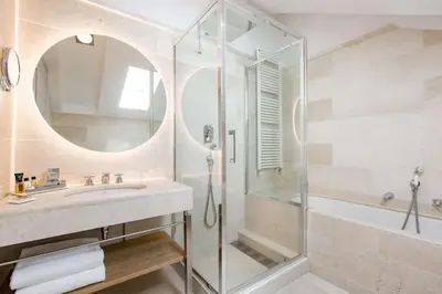 a bathroom with a sink and a shower at Grand Hotel Savoia Cortina d'Ampezzo, A Radisson Collection Hotel in Cortina dʼAmpezzo