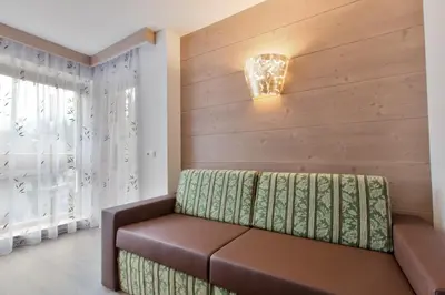 a living room with a couch and a window at Apartments Ciasa Costa in Badia