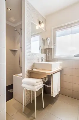 a bathroom with a sink and a mirror at Hotel La Sorgente in Tesero
