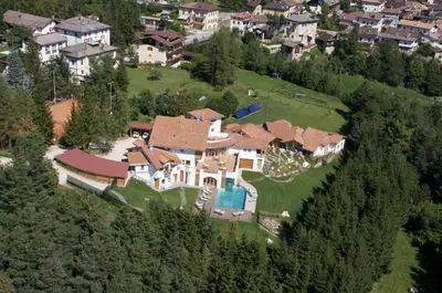 an aerial view of a large house on a hill at Castelir Suite Hotel in Panchia
