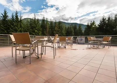 a group of chairs and tables on a patio at Castelir Suite Hotel in Panchia