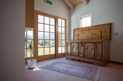 a room with a fireplace and a large window at Castelir Suite Hotel in Panchia