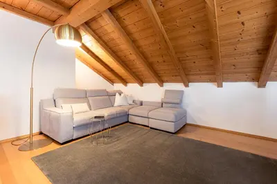 a living room with a couch and two chairs at Die Villa bei Meran in Marlengo