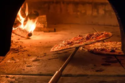 two slices of pizza being cooked in an oven at Residence Egger in Terlano