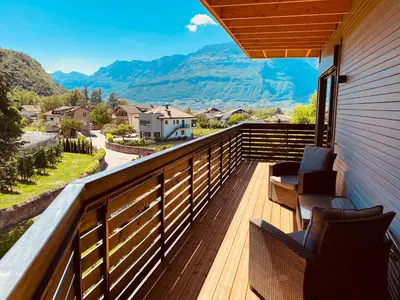 a balcony with chairs and a view of mountains at Julias Guesthouse in Ora/Auer