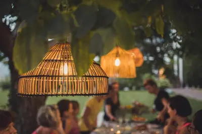 a group of people sitting at a table with lights at Julias Guesthouse in Ora/Auer