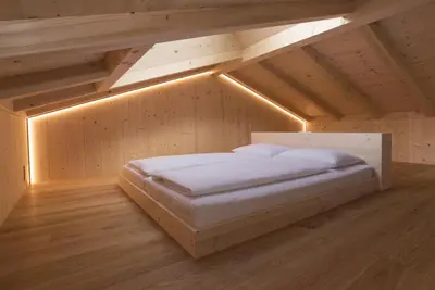 a bedroom with a bed in a attic at Greiterhof in Lana