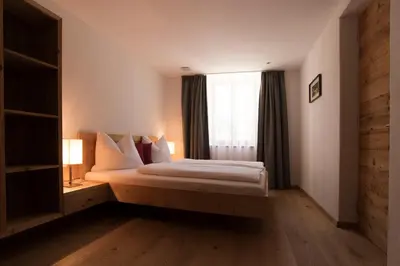 a bedroom with a large bed with a window at Greiterhof in Lana