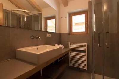 a bathroom with a sink and a shower at Greiterhof in Lana