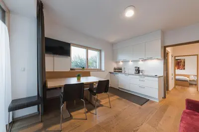 a kitchen and dining room with a table and chairs at Weingut Messnerhof in Bolzano