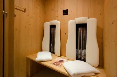 a room with two white vases on a wooden shelf at Apartments Victoria in Ortisei