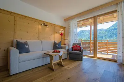 a living room with a couch and a table at Apartments Victoria in Ortisei