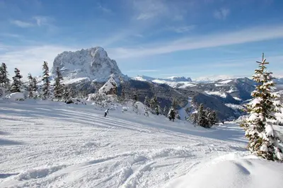 a person is skiing down a snow covered mountain at Apartments Victoria in Ortisei