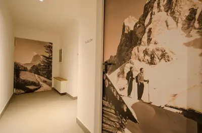 a hallway with a painting of two people on a wall at Apartments Victoria in Ortisei